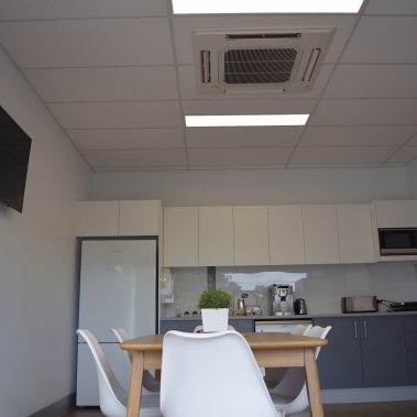 Office kitchen with air conditioning duct on the ceiling